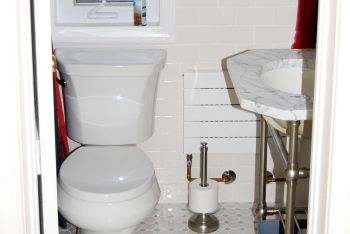 Small half-bath with a white toilet.