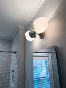 New wall sconce in a remodeled bathroom.