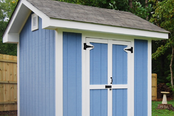 A blue wooden shed with white trim.