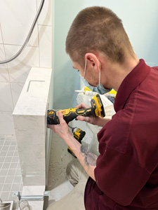 Caffi employee using a tool for remodeling services