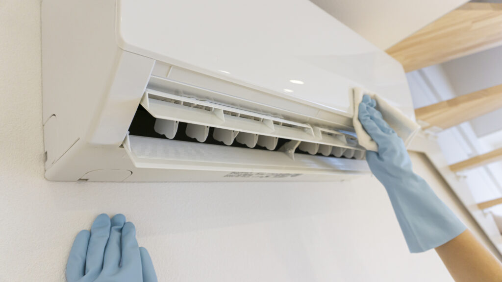 Technician cleaning the indoor air handler on a ductless mini split