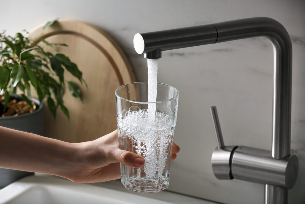 Closeup of glass filling with filtered tap water