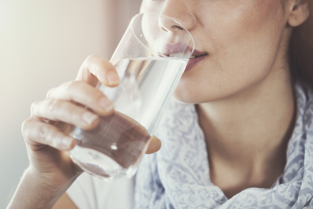 Closeup of woman drinking filtered water